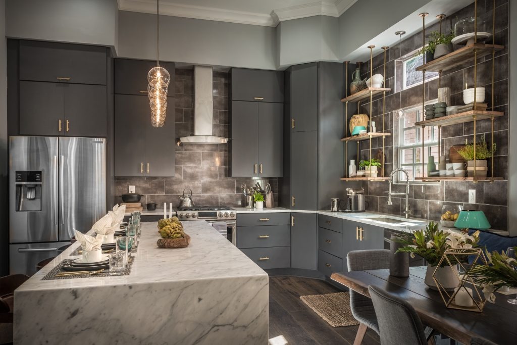 A modern white kitchen with dark wood accents and custom cabinetry.